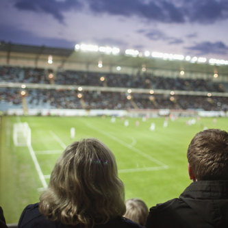 Image of rear-view-of-people-watching-soccer-match-at-stadi-2023-11-27-05-30-50-utc