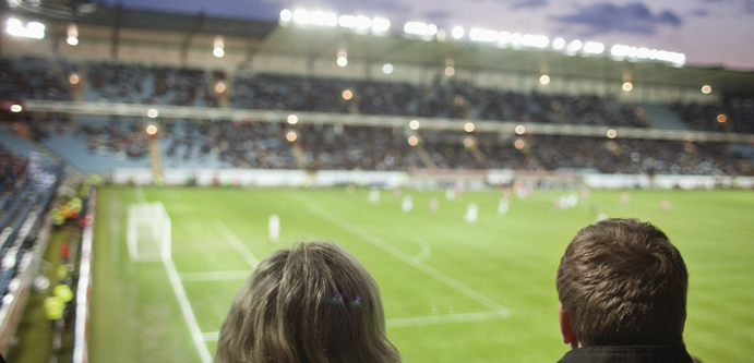 Image of rear-view-of-people-watching-soccer-match-at-stadi-2023-11-27-05-30-50-utc